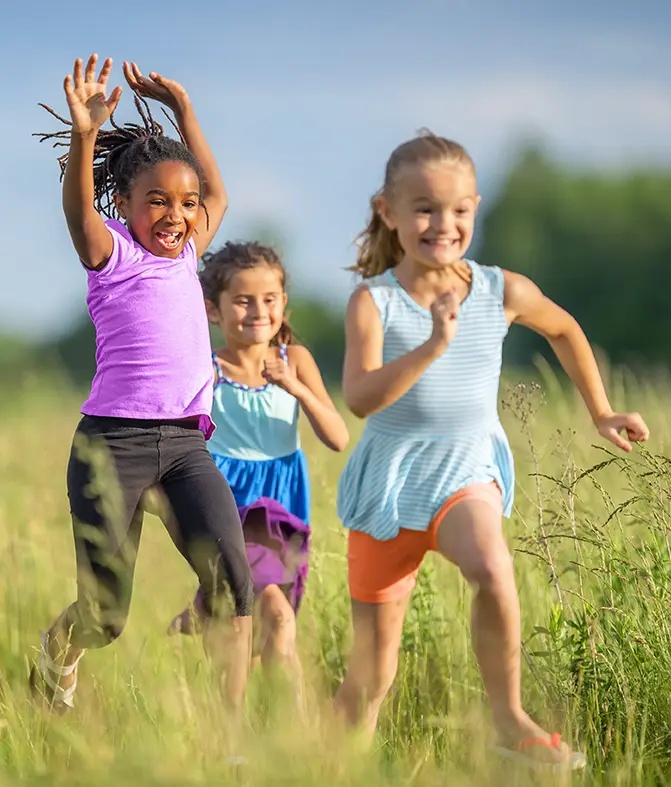 Girls running through a field
