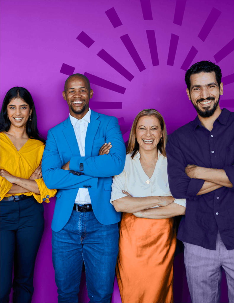 Four people stand side by side in front of a purple background with a sunburst design, all smiling with arms crossed, dressed in business casual attire.