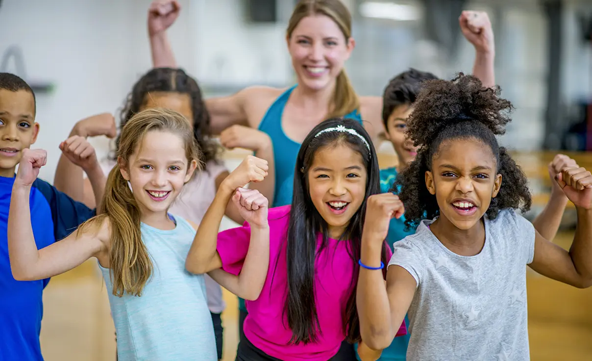 Donation-Change-Lives-Image-2 Group of kids flexing their arms