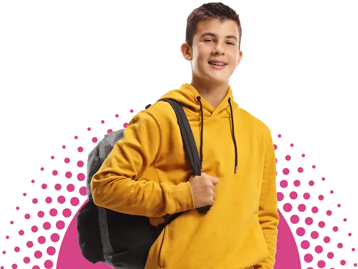 Teenage boy wearing a yellow hoodie and carrying a backpack over one shoulder, standing and smiling at the camera.