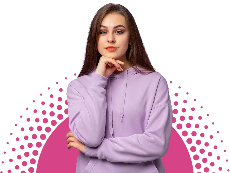 A young woman with long brown hair wearing a lavender hoodie stands with her hand under her chin, looking directly at the camera. The background features a pixelated pink and white design.