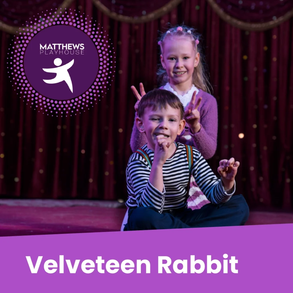 Two children sit on stage making bunny ears with their fingers. A "Matthews Playhouse" logo and the words "Velveteen Rabbit" appear on the image.